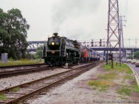 CNR 6060 departs Toronto on its last excursion before retirement and relocation to Alberta.  Here, the "bullet-nosed Betty" eases up the Bala Sub just north of the Queen Street overpass <a href=https://www.railpictures.ca/?attachment_id=53417>and the former Don station site.</a>

<br><br>This trip was the main event of the National Railway Historical Society's 1980 convention, running from July 23 - July 27.  Events included a trip and tour of the TTC subway lines, a trip to Niagara Falls behind 6060 (second last trip), TTC streetcar charters and night photo session, night photo session at Agincourt yard, GO Transit charter throughout the system, including a side trip from Georgetown to the Halton County Radial Railway by bus, 6060's farewell trip to Newmarket via Washago and return via Allandale.  A train of American equipment, the <i>Independence Limited,</i> behind a set of Southern and Norfolk & Western power, was also in attendance with a string of private cars.


<br><br>More from the final trip:
<br><a href=https://www.railpictures.ca/?attachment_id=22764>6060 in the Don Valley by Greg Roach</a>
<br><a href=https://www.railpictures.ca/?attachment_id=21174>6060 in the Don Valley by Peter Newman</a>
<br><a href=https://www.railpictures.ca/?attachment_id=37301>6060 at Richmond Hill by First954</a>
<br><a href=https://www.railpictures.ca/?attachment_id=22765>6060 at Gormley by Greg Roach</a>
<br><a href=https://www.railpictures.ca/?attachment_id=27699>6060 near Allandale by Peter Newman</a>
<br><a href=https://www.railpictures.ca/?attachment_id=17841>6060 at Allandale by Peter Newman</a>
<br><a href=https://www.railpictures.ca/?attachment_id=18490>6060 meet at Allandale by Peter Newman</a>
<br><a href=https://www.railpictures.ca/?attachment_id=53444>6060's crew at the end of the run by Tony Bock</a>


<br><br>More from the convention:
<br><a href=https://www.railpictures.ca/?attachment_id=22439>Niagara bound, second last trip, Dave Beach</a>
<br><a href=https://www.railpictures.ca/?attachment_id=14794>Returning through Merritton, Arnold Mooney</a>
<br><a href=https://www.railpictures.ca/?attachment_id=49097>Crossing Jordan Harbour, Unknown Photographer</a>
<br><a href=https://www.railpictures.ca/?attachment_id=14680>Second last run at Toronto, Steve Danko</a>
<br><a href=https://www.railpictures.ca/?attachment_id=40987>Independence Limited departing Toronto, Steve Bradley</a>
<br><a href=https://www.railpictures.ca/?attachment_id=6765>Independence Limited at Burlington West, Arnold Mooney</a>


<br><br><i>J. Bryce Lee Photo, Jacob Patterson Collection Slide.</i>
