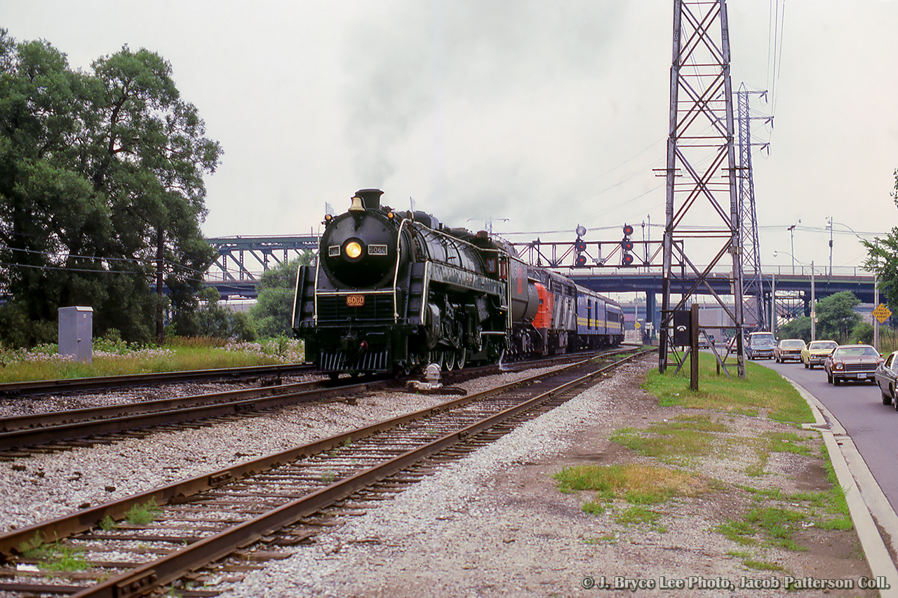 CNR 6060 departs Toronto on its last excursion before retirement and relocation to Alberta.  Here, the "bullet-nosed Betty" eases up the Bala Sub just north of the Queen Street overpass and the former Don station site.

This trip was the main event of the National Railway Historical Society's 1980 convention, running from July 23 - July 27.  Events included a trip and tour of the TTC subway lines, a trip to Niagara Falls behind 6060 (second last trip), TTC streetcar charters and night photo session, night photo session at Agincourt yard, GO Transit charter throughout the system, including a side trip from Georgetown to the Halton County Radial Railway by bus, 6060's farewell trip to Newmarket via Washago and return via Allandale.  A train of American equipment, the Independence Limited, behind a set of Southern and Norfolk & Western power, was also in attendance with a string of private cars.


More from the final trip:
6060 in the Don Valley by Greg Roach
6060 in the Don Valley by Peter Newman
6060 at Richmond Hill by First954
6060 at Gormley by Greg Roach
6060 near Allandale by Peter Newman
6060 at Allandale by Peter Newman
6060 meet at Allandale by Peter Newman
6060's crew at the end of the run by Tony Bock


More from the convention:
Niagara bound, second last trip, Dave Beach
Returning through Merritton, Arnold Mooney
Crossing Jordan Harbour, Unknown Photographer
Second last run at Toronto, Steve Danko
Independence Limited departing Toronto, Steve Bradley
Independence Limited at Burlington West, Arnold Mooney


J. Bryce Lee Photo, Jacob Patterson Collection Slide.