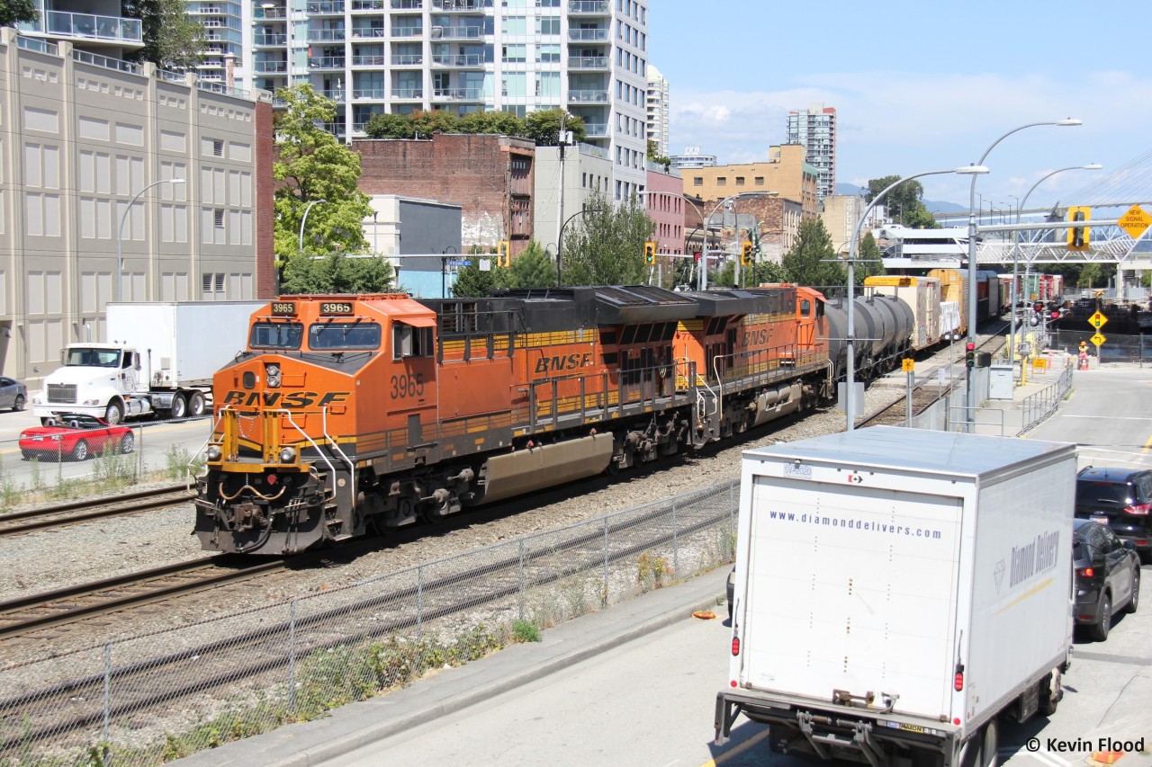 When we were living in the Vancouver area, I really enjoyed this spot in New Westminster. It was a packed scene. The train line through here is super busy with numerous transfer trains passing through including BNSF, CPKC, CN and SRY. On a beautiful Vancouver summer day, a BNSF transfer train from Thornton Yard in Surrey is heading to SRY's Trapp Yard. I saw this train from the Skytrain about to cross the Fraser River but had no idea whether it was going north or south on the other side of the river. Spending time with family, and my wife meeting with an old colleague, I heard bells ringing and sure enough it was the BNSF transfer heading through. We were steps from the tracks so I naturally brought my camera. I can't stop talking about this place. Stuff for the family and numerous trains right there. There's a boardwalk, park, and children's play area adjacent to the tracks. This was the first of three SB trains I caught, including SRY and CN to follow.