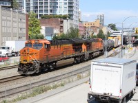 When we were living in the Vancouver area, I really enjoyed this spot in New Westminster. It was a packed scene. The train line through here is super busy with numerous transfer trains passing through including BNSF, CPKC, CN and SRY. On a beautiful Vancouver summer day, a BNSF transfer train from Thornton Yard in Surrey is heading to SRY's Trapp Yard. I saw this train from the Skytrain about to cross the Fraser River but had no idea whether it was going north or south on the other side of the river. Spending time with family, and my wife meeting with an old colleague, I heard bells ringing and sure enough it was the BNSF transfer heading through. We were steps from the tracks so I naturally brought my camera. I can't stop talking about this place. Stuff for the family and numerous trains right there. There's a boardwalk, park, and children's play area adjacent to the tracks. This was the first of three SB trains I caught, including SRY and CN to follow. 