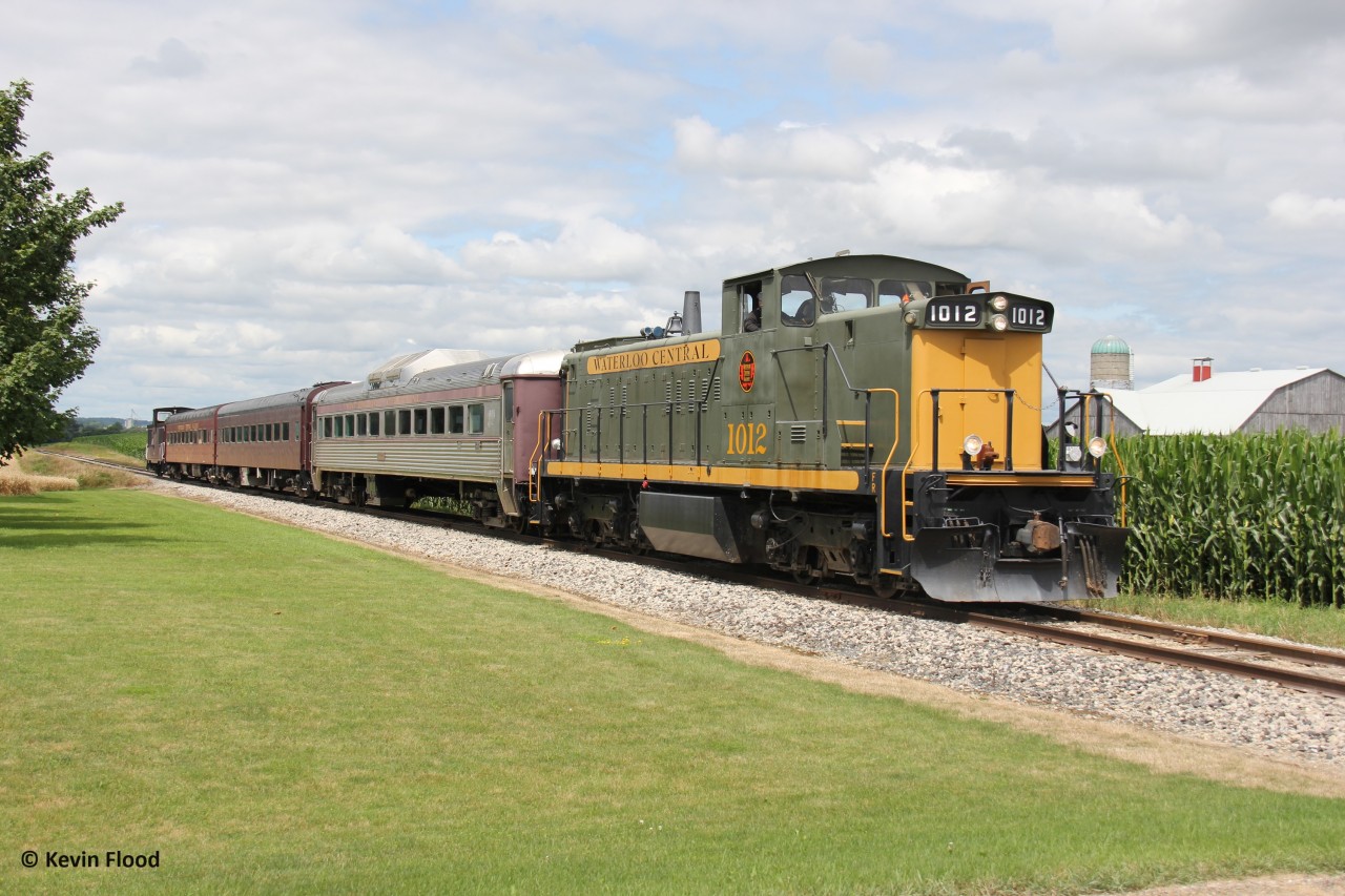 The WCR tourist/market train heads south back to the Farmer's Market after its 15:00 stop at Elmira. I just discovered this crossing for this shot, and I love the farm-like scene here combined with WCR's beautifully restored and repainted GMD-1 (ex CN 1437). More information about the WCR can be found here: https://waterloocentralrailway.com/.