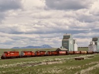 Just north of the USA border and interchange with BNSF at Sweetgrass, Montana, and with the tailend still in Montana, a northward train to Lethbridge has CP 5810 + 5801 + 5759 + 5813 (a planned-for-Locotrol consist if ever I saw one) for power as it gets underway at Coutts, Alberta, on Friday 1989-05-26 at 1401 MDT.

<p>Lethbridge was originally in downtown, but was relocated 8 miles west (and beyond the viaduct across the Oldman River) to new Lethbridge formerly Coalhurst and Kipp.