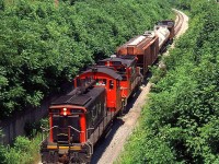CN 549 with CN SW1200RS 1385 and 1388 climbed the grade at Service Rd. W. on the CN Thorold Sub from Merritton to Thorold in July 1998.
