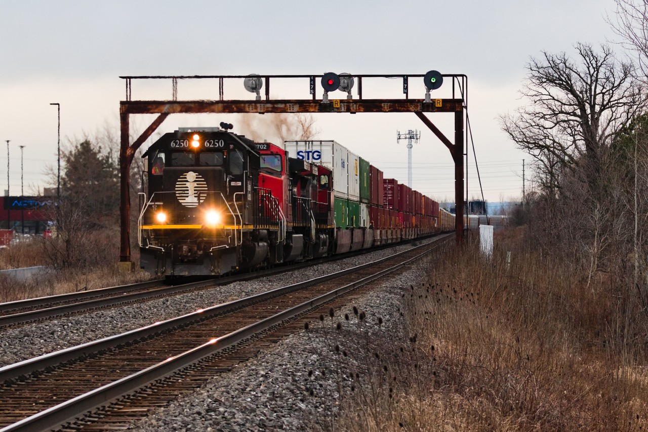 A fallen flag EMD 645 leading double stacks at track speed on the Halton... need I say more? Q122 and the NTSB regulations which screwed it was left with an outlawed C44-9W pair, one dead and one without the mercy of PTC exemptions. A miraculous retaliation from Battle Creek gifted them with IC 6250, an internationally friendly PTC & LVVR equipped 6-axle (both things CN hasn't finished equipping to some ex-CREXs). Here they are sweeping north on the approach to Tansley as they hit the outskirts of Burlington to begin their battle upgrade. Had the circumstances applied to anything else offered by CN with work along the way, we could reasonably expect that it would have been a treat exclusive to the Americans. I can't say I've recieved many shocks to the system quite like this train gave me, as I had to do a lot of convincing to myself to believe that such an event was actually going to turn out well for me. Night train, backlit sun, dropped before the border... I was waiting for an excuse to justify not going out for it. I assume these things were more common back in the days of early 2000s foreign power?