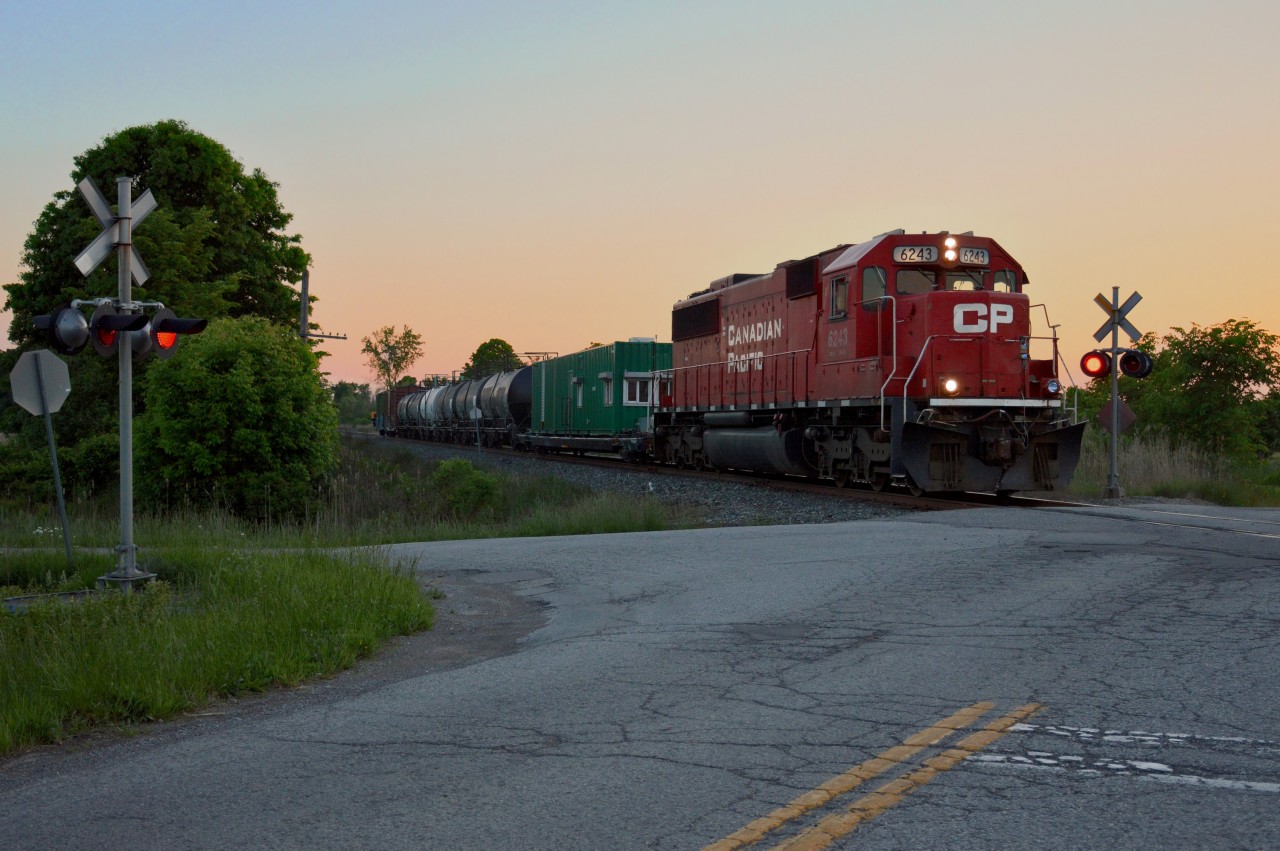 CP SD60 6243 pushes the Weed Sprayer train back south down the Montrose Subdivision at the Biggar and Crowland Road crossing after spraying going north.