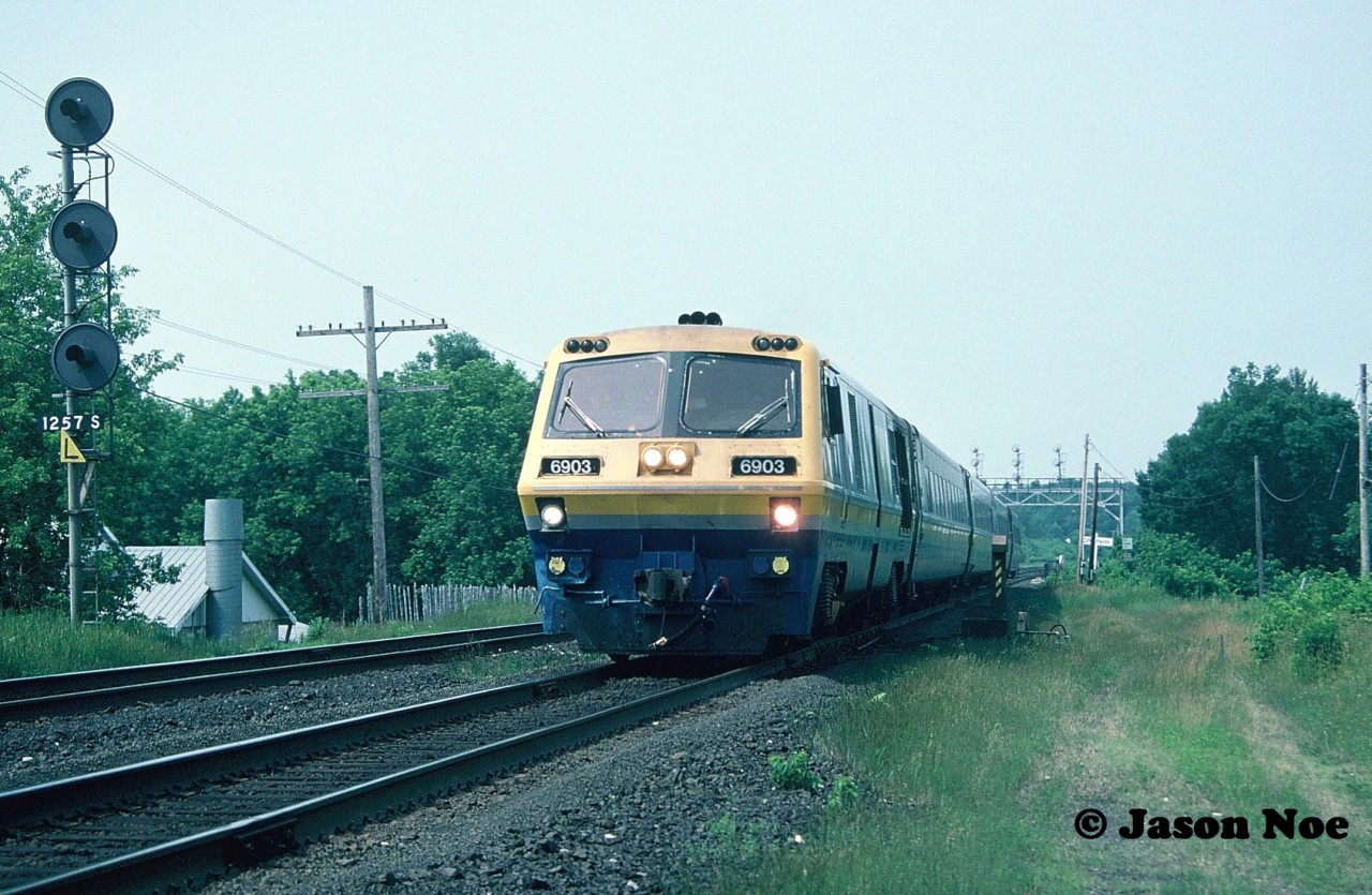 An eastbound VIA Rail train is pictured slowing for its station stop at Brockville, Ontario on the CN Kingston Subdivision. The train was heading to Montreal, Quebec and was powered by LRC-2 6903.