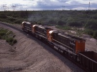 "Off into the Sunset".  I rather like this shot which was taken off the Hwy 138 bridge just north of town if I remember correctly.  Cartier 87, 75 and 76 are off into the north, destination Mont-Wright.
It would be 30 years before these big MLW M-636's would go off into their private 'sunset'; with #87 (x-CN 2331) and 76 being sold to the scrapper in 2011. The other unit lived onward, recently noted as WNYP 638.