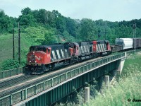 CN M-420(W) 3578, M-636 2314 and SD40 5071 lead a westbound over the Highway 403 bridge as it begins its trip over the CN Dundas Subdivision at Hamilton West, Ontario. 