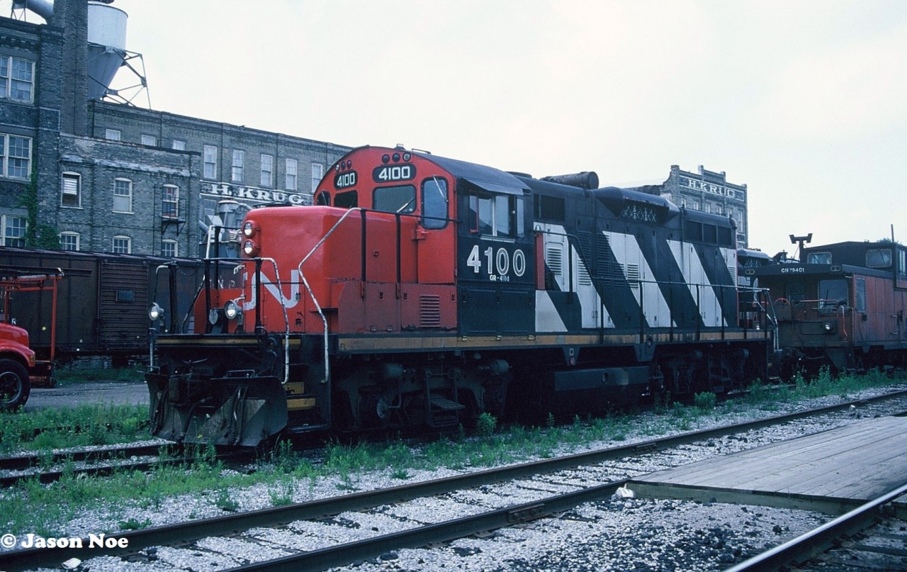 During a hazy summer evening, CN GP9RM 4100 waits for its next assignment at Kitchener, Ontario, along with caboose 79401. Over the years, 4100 was assigned to Kitchener on several occasions, with this being the first time I ever photographed it there.

Now, more than 30 years later and 4100 is currently freshly re-painted and re-lettered LDSX 4100 for GIO Rail. The unit was completed at the Sarnia, Ontario based Lambton Diesel Specialists shop. This unit, along with a pair of former IC SW14’s had been acquired by LDS during 2023 after languishing stored unserviceable in the Niagara/ Welland area for sometime. As of July 12, LDSX 4100 was still observed at the LDS shop in Sarnia awaiting its first assignment on GIO Rail.