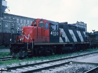 During a hazy summer evening, CN GP9RM 4100 waits for its next assignment at Kitchener, Ontario, along with caboose 79401. Over the years, 4100 was assigned to Kitchener on several occasions, with this being the first time I ever photographed it there.
<br>
Now, more than 30 years later and 4100 is currently freshly re-painted and re-lettered LDSX 4100 for GIO Rail. The unit was completed at the Sarnia, Ontario based Lambton Diesel Specialists shop. This unit, along with a pair of former IC SW14’s had been acquired by LDS during 2023 after languishing stored unserviceable in the Niagara/ Welland area for sometime. As of July 12, LDSX 4100 was still observed at the LDS shop in Sarnia awaiting its first assignment on GIO Rail.  
