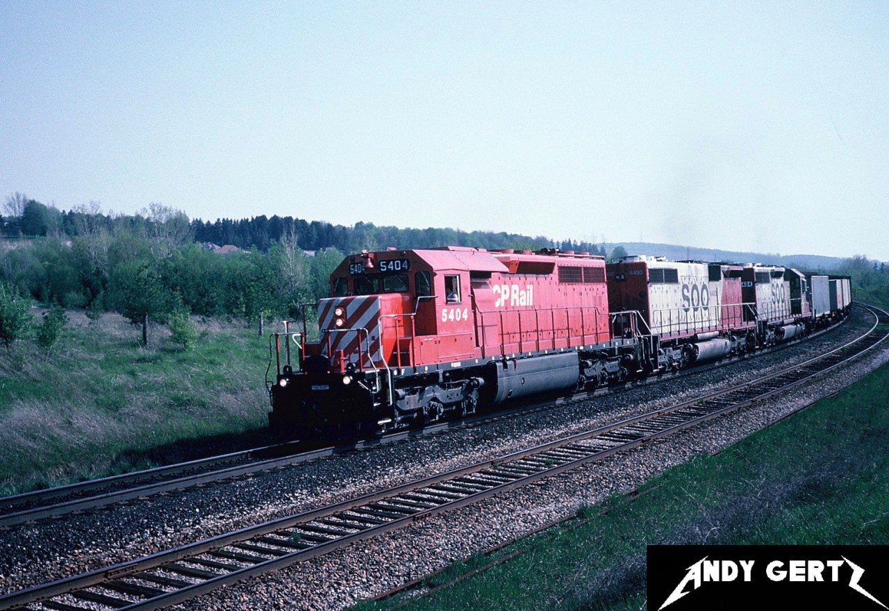 An eastbound CP intermodal train is passing Coakley siding on the Galt Subdivision, east of Woodstock, Ontario. The train is powered by CP SD40 5404, SOO Line SD40B 6450 and SOO Line SD40 6404.