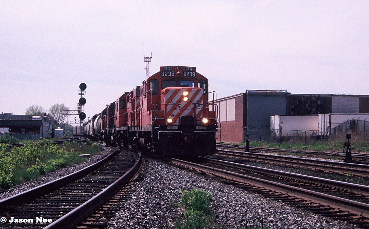 CP GP9u 8238 with three other units is pictured leading an eastbound departing Lambton yard in Toronto, Ontario. The train is on the North Toronto Subdivision about to cross the West Toronto diamonds.