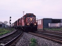 CP GP9u 8238 with three other units is pictured leading an eastbound departing Lambton yard in Toronto, Ontario. The train is on the North Toronto Subdivision about to cross the West Toronto diamonds. 