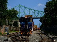 A Port of Montreal switcher is shoving back with stacks as CN 500 in the distance gets ready to leave the port.