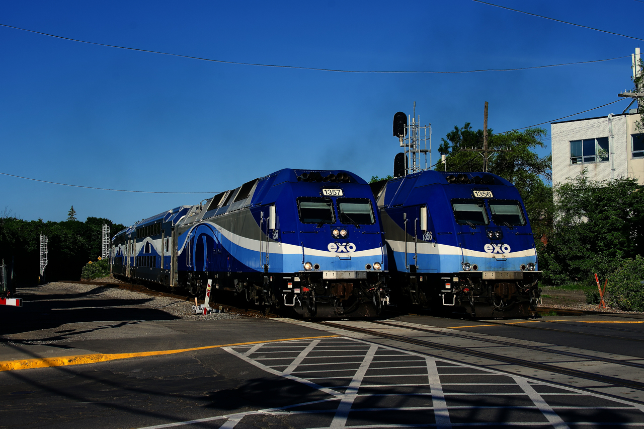 Consecutively numbered locomotives are passing by the Westminster crossing as EXO 112 and EXO 41 head in opposite directions.