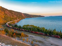 Another memorable day out on the Nipigon Sub with my good friend Kyle. It had been a few years since the two of us teamed up to foam the Thunder Bay area and this day we picked up as if we never left. Train 112 had been held most of the day in Thunder Bay, just being shy of 12,000' and unable to meet 113, who also was just shy of the 12,000' mark. Once they got going they were informed they would meet 101-28 at Firehill, who was still an hour and a half east of Schreiber. We followed 112 to Nipigon where Kyle and I sprung over to Cavers. It's been close to 11 years since the two of us had shot from the old pit along the shores of Lake Superior and needless to say neither one of us recalled it being that difficult to ascend the steep sand face of the old pit. After what seemed as an eternity of taking one step forward, two steps back we both got into our respected spots. Sitting there "recovering", it was quite peaceful and relaxing. The squirrels playing amongst the foliage atop the pit, the gentle lap of the waves of Superior against the rocky shoreline. A calm breeze... but no sign of CP's hotshot. With them on duty over an hour and a half thoughts of "did we skip over him" went through my mind, as we had stopped to check a couple spots on the way over from Nipigon. After about 20 minutes a distant rumble could be heard. Perfect! It shouldn't be too much longer now.... how wrong I was. I forgot how clear you can hear a westbound coming out of Rossport/approaching Pays Plat. For close to 30 minutes the rumble grew louder than became more distant, all the while the sun continued to dip lower on the horizon. Keeping our eyes pealed out to the point waiting and praying for a glimpse of a headlight. Just as I checked my settings on my camera, Kyle yelled out to warn our prize was in sight and our efforts were about to be rewarded. Shutters snapped as we recorded CP 8011 West snaking along the rocky northern shores of Lake Superior. By the time the tailend of the the 10,000' hot shot had passed, the sun had set. We slid down the embankment and back to our car to return to TBay to grab a pint and pizza from our old haunt and to watch the Blue Jays contend for a wild card spot. - They didn't make it.