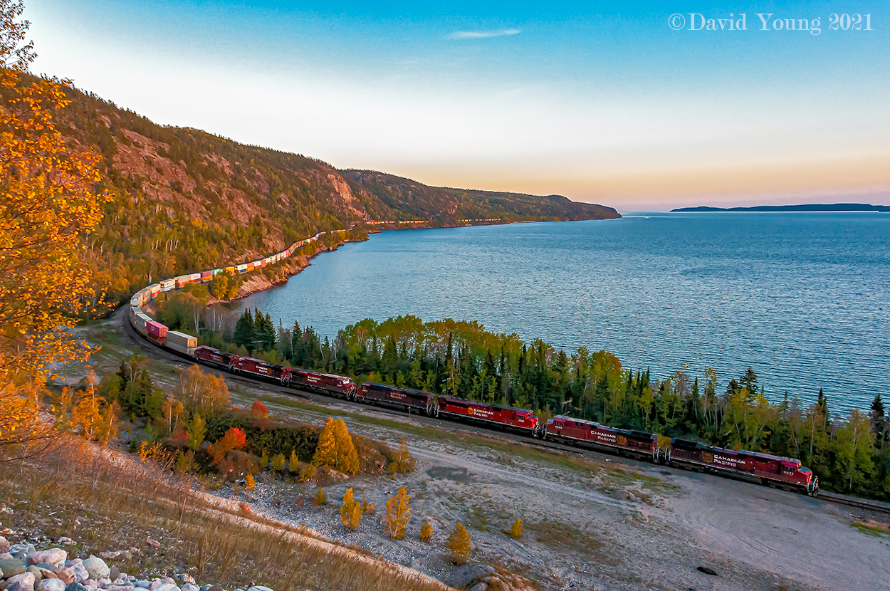 Another memorable day out on the Nipigon Sub with my good friend Kyle. It had been a few years since the two of us teamed up to foam the Thunder Bay area and this day we picked up as if we never left. Train 112 had been held most of the day in Thunder Bay, just being shy of 12,000' and unable to meet 113, who also was just shy of the 12,000' mark. Once they got going they were informed they would meet 101-28 at Firehill, who was still an hour and a half east of Schreiber. We followed 112 to Nipigon where Kyle and I sprung over to Cavers. It's been close to 11 years since the two of us had shot from the old pit along the shores of Lake Superior and needless to say neither one of us recalled it being that difficult to ascend the steep sand face of the old pit. After what seemed as an eternity of taking one step forward, two steps back we both got into our respected spots. Sitting there "recovering", it was quite peaceful and relaxing. The squirrels playing amongst the foliage atop the pit, the gentle lap of the waves of Superior against the rocky shoreline. A calm breeze... but no sign of CP's hotshot. With them on duty over an hour and a half thoughts of "did we skip over him" went through my mind, as we had stopped to check a couple spots on the way over from Nipigon. After about 20 minutes a distant rumble could be heard. Perfect! It shouldn't be too much longer now.... how wrong I was. I forgot how clear you can hear a westbound coming out of Rossport/approaching Pays Plat. For close to 30 minutes the rumble grew louder than became more distant, all the while the sun continued to dip lower on the horizon. Keeping our eyes pealed out to the point waiting and praying for a glimpse of a headlight. Just as I checked my settings on my camera, Kyle yelled out to warn our prize was in sight and our efforts were about to be rewarded. Shutters snapped as we recorded CP 8011 West snaking along the rocky northern shores of Lake Superior. By the time the tailend of the the 10,000' hot shot had passed, the sun had set. We slid down the embankment and back to our car to return to TBay to grab a pint and pizza from our old haunt and to watch the Blue Jays contend for a wild card spot. - They didn't make it.