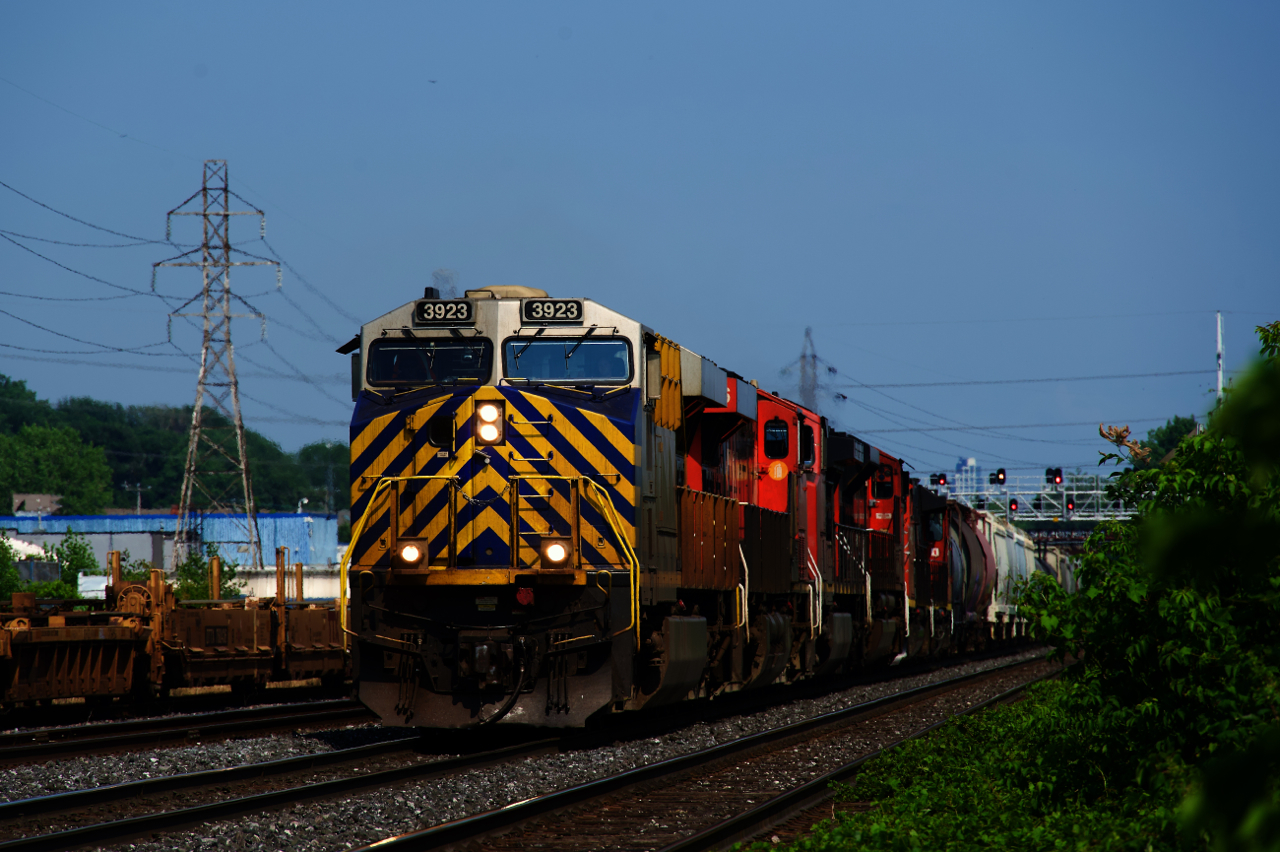 CN 527 has six units as it heads west on the Montreal Sub. At left, well cars are stored on the Transfer Track.