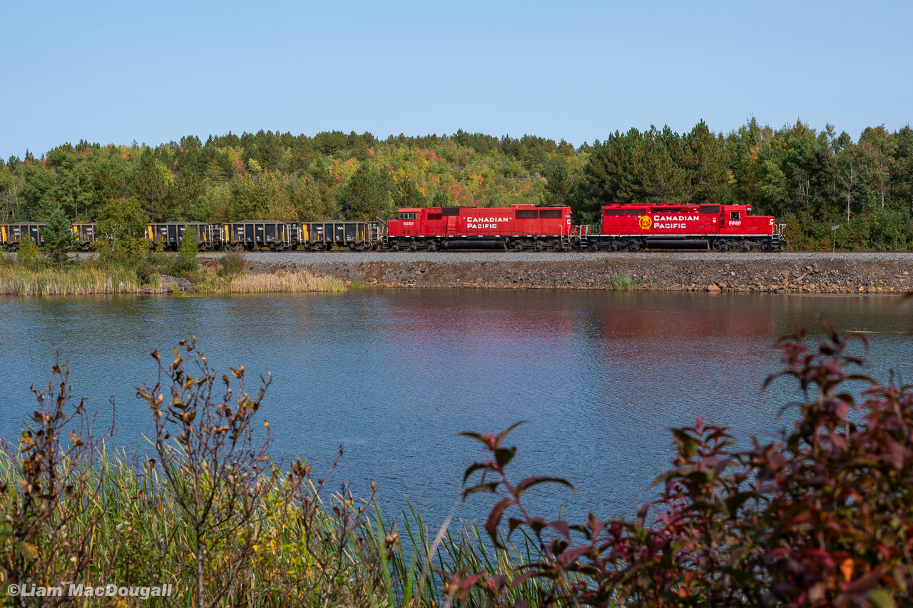 CP H55 has an attractive lashup of an SD40-2 & SD60M as they pass a cool little trackside pond at the Sprecher Mileboard on the Cartier Sub. Once clear the main and into the spur they'd detach from their loaded nickel ore cars and leave them for VALE to take at some point later on.