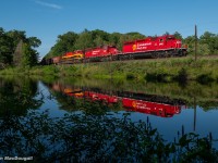 On a gorgeous July evening, CP 6011 leads loaded ballast train GPS-14 through the causeway at the north end of Long Lake in Bala, ONT. Making pretty good time from a noon departure at Cartier, they're doing every bit of track speed to get to Buckskin to meet northbound manifest train #421. 