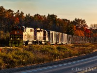 A chance encounter along Highway 17 with the eastbound Huron Central freight. HCRY GP40-2W 3013 and leased CP SD40-2 6030 trundle 34 car train of forest and steel goods along at sunset.