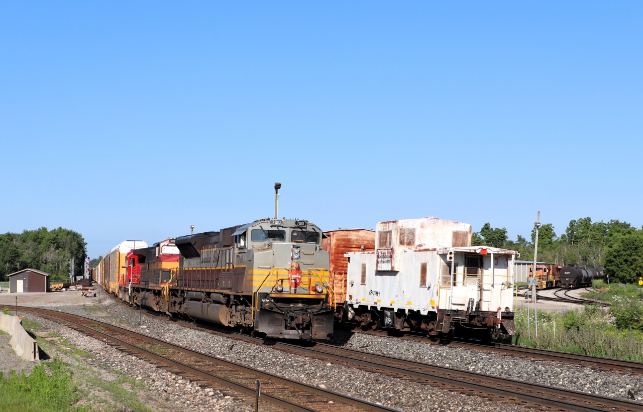 With the CWR train sitting waiting for the eastbound CPKC 134 to clear, its tail end Engineering Services MOW caboose 420984, makes a nice back drop for CP 7010. The former CP 9153, now all decked out in its heritage script paint job, rolls on by at track speed as it prepares to depart Guelph Junction. Aiding in the power are KCS 4592 and CP 3024.