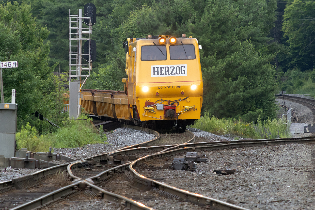 Hot train is coming, so the shortest stack train......OK, it's a tie distribution train sneaks back into South Parry. I worked a tir collection job for CN on the Mountain Park Sub in 1983. We used empty flat cars, and a front end loader with a claw to pick them up. Every single time, I was sure it was going to tip....craziness.