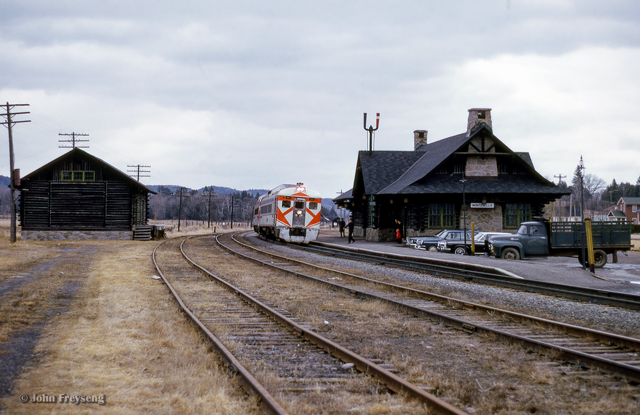 A pair of Ottawa-bound CPR dayliners running as Saturday only train 137 pause at Montebello, Quebec.  This log station, constructed in 1931, replacing an earlier structure.  Serving its last train in 1981, the station was relocated to main street in 1989 where it now serves as a tourist information centre.<Scan and editing by Jacob Patterson.