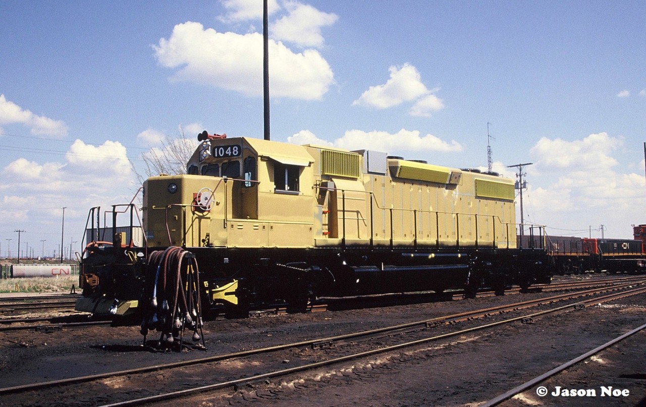 Newly built Orinoco Mining SD38-2TC 1048 is seen at CN’s MacMillan Yard in Vaughan, Ontario. The unit was on route from the GMDD plant in London to the AMF facility in Montreal, Quebec for contract painting. This was a mining railroad in Venezuela, that had eight units manufactured and painted in Canada, which were loaded on a ship in Halifax during June of that year to reach their destination.