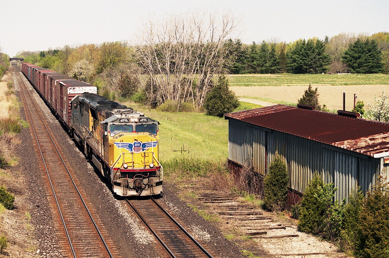 The daily NS Talbotville Ont to Buffalo NY auto parts train ceased to operate some years ago. Its a shame, as it was a huge fan favourite. There seemed to be no end to the locomotive combinations that could appear on this train. An example is this view of UP 4896 and CSX 8973 powering the eastbound on a pleasantly warm May morning. On the right is the very last of its' kind in Niagara; a free standing building that was used for fresh fruit storage. The siding has been pulled up and the building is soon to be demolished. At one time every community along the line here had a facility like this, and in season a wayfreight would stop and load up perishables to ship to Toronto.
Its all a memory now. The business has been lost to the trucks.