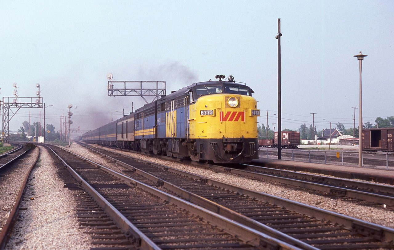 Warm and windy late afternoon at Burlington West, I'm hanging out around the dinner hour as it was a busy time for VIA.  Here we see VIA 6773 barreling thru at a good clip heading west. Note the yard in behind the station is unusually quiet. CP and CN both serviced this yard, and they had departed for the day.
Track on left is the western end of the Halton Sub. Freight only.