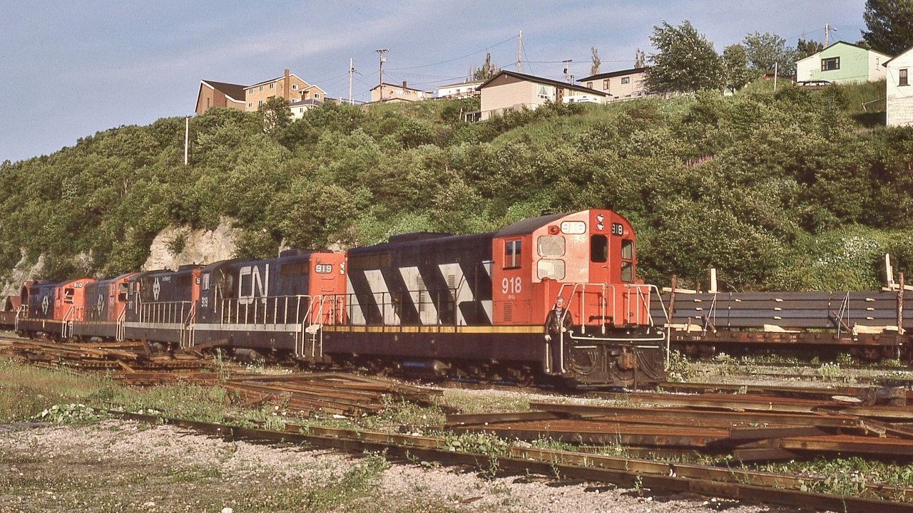 TT daily train #204's power: 


four GMD 1956 to 1960 built NF210's: TT#910 / TT#940 / TT#917 / TT#919 (CN noodle) 


plus TT#918 in tow:  CN  zebra livery - ground out relay issue


Train 204 into Cornerbrook with seventy plus rail cars and TT van #6053. 


At Cornerbrook, August 2, 1982 Kodachrome by S.Danko


Question for Ken: any chance identifying the Brakeman  / Trainman ?


More #204:


       on the Road