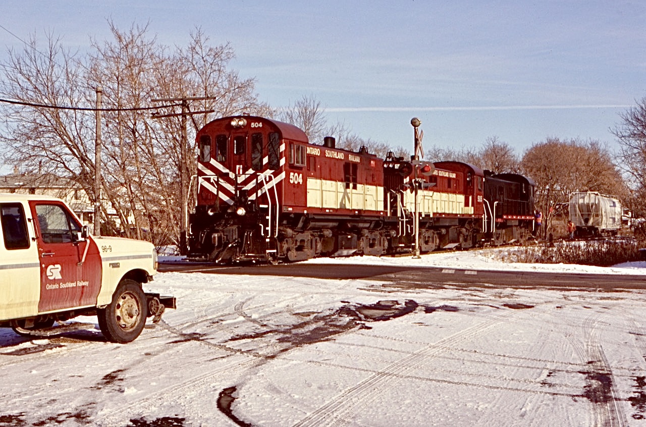 Thanks to the OSR I quickly grew a big fascination to the MLW RS23 model. For a period of time they were regulars on the job to Guelph. Typically in  the form of pairs or a trio.  The sound was great either way. Here a trio of RS23’s also known as “rockets” by some, are seen working the Owen’s Corning spur with a lone covered hopper. The OSR truck placed itself nicely in the image as their waited to test the crossing signals.