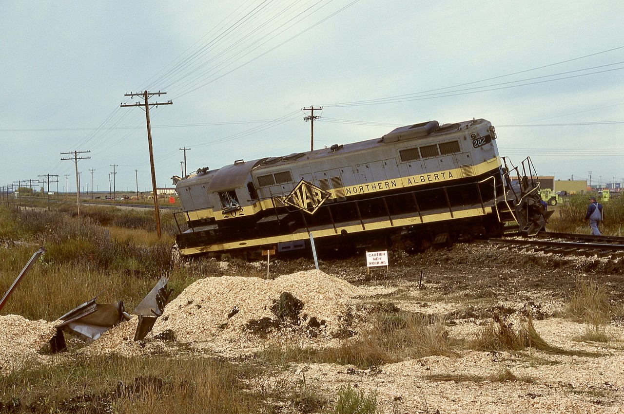 On the west side of Grande Prairie, 108th Street carrying Highway 40 crossed Northern Alberta Railways at mileage 50.91 of the Grande Prairie subdivision heading west to Dawson Creek.  From the debris seen there on Monday 1978-09-25 with GP9 202 rather uncomfortably parked and the scattered remains of a loaded woodchip truck which had experienced a rapid unscheduled disassembly, it appeared that the Dawson Creek wayfreight train No. 51 on the preceding Friday did not reach its destination.  That crossing was notorious for such collisions.