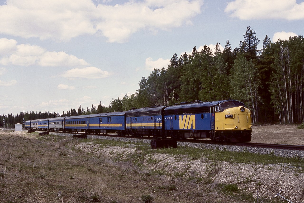 Yates, Alberta, is the first station east of a crew change point at Edson on CN’s Edson sub., and is immediately west of a steel bridge over the McLeod River.  On Sunday ﻿1987-05-24, VIA train No. 4 was powered by VIA 6313 + 6607 as it departed the east switch (note signals in the distance) and headed for the bridge and onward to Edmonton.
﻿
﻿This post on Monday 2024-08-12 is recognition of the 28th anniversary of Monday 1996-08-12 when westward CN train symbol 117 encountered a rolling runaway cut of twenty cars from the yard at Edson, with three fatalities, at the precise location of my photo a bit over nine years earlier.

Having been involved as a locomotive event recorder technician in numerous accident investigations, the ones hardest to deal with were where fatalities occurred in locations known well from photos taken there and with the crew totally blameless.  In the 1996 collision at Yates, conductor Kenneth Robert Trout and engineer Jacob Charles Elder plus visitor John Eric Fraser were lost.