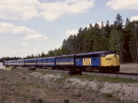 Yates, Alberta, is the first station east of a crew change point at Edson on CN’s Edson sub., and is immediately west of a steel bridge over the McLeod River.  On Sunday ﻿1987-05-24, VIA train No. 4 was powered by VIA 6313 + 6607 as it departed the east switch (note signals in the distance) and headed for the bridge and onward to Edmonton.
﻿
﻿<p>This post on Monday 2024-08-12 is recognition of the 28th anniversary of Monday 1996-08-12 when westward CN train symbol 117 encountered a rolling runaway cut of twenty cars from the yard at Edson, with three fatalities, at the precise location of my photo a bit over nine years earlier.

<p>Having been involved as a locomotive event recorder technician in numerous accident investigations, the ones hardest to deal with were where fatalities occurred in locations known well from photos taken there and with the crew totally blameless.  In the 1996 collision at Yates, conductor Kenneth Robert Trout and engineer Jacob Charles Elder plus visitor John Eric Fraser were lost.