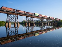 CPKC 113 is the last of the overnight westbound "rush" on the Belleville Sub as it crosses the Trent River, soon giving way to a handful of daytime eastbound trains.