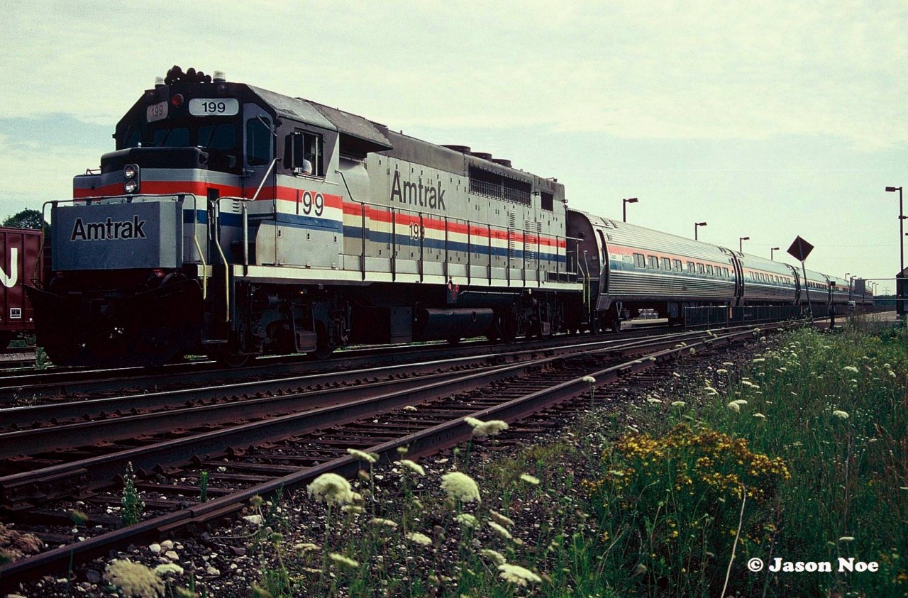 Amtrak GP40TC 199 is pictured during its station stop at the Aldershot, Ontario station on the CN Oakville Subdivision. This unit was originally built in December 1966 as CN 607 and later became GO Transit 607 upon the formation of the commuter agency during spring 1967.