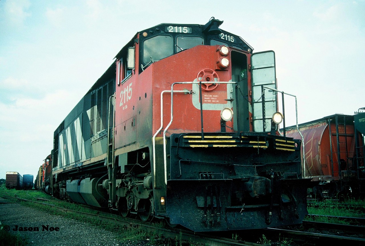 During a hazy summer evening, CN 421 with HR616 2115 and M-636 2328 are pictured working the Kitchener Yard on the CN Guelph Subdivision. According to my slides, the crew is lifting a GP9RM out of the yard to take west with them. Unfortunately, I didn’t record the number of the GP9RM at the time.