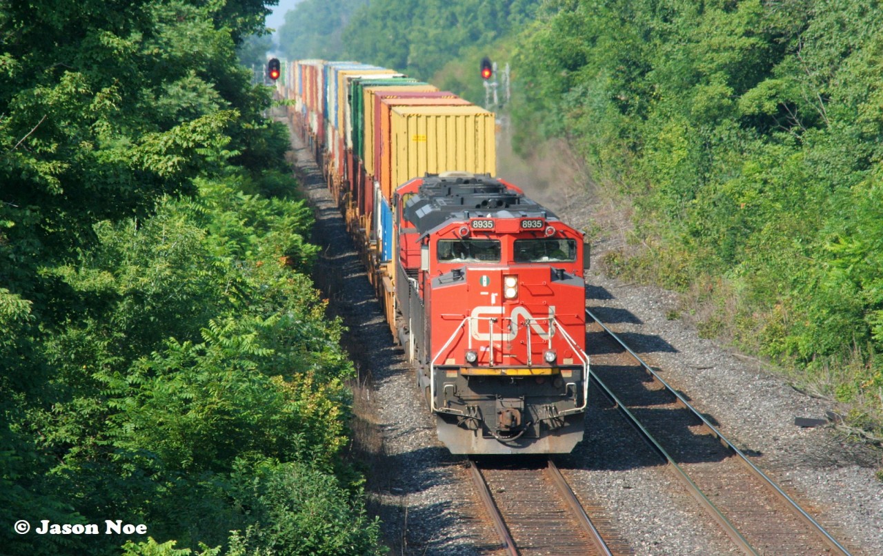 A CN eastbound container train with 8935 and 8010 has just passed through the town of Princeton, Ontario on the CN Dundas Subdivision and is approaching the recently upgraded Blenheim Road bridge.