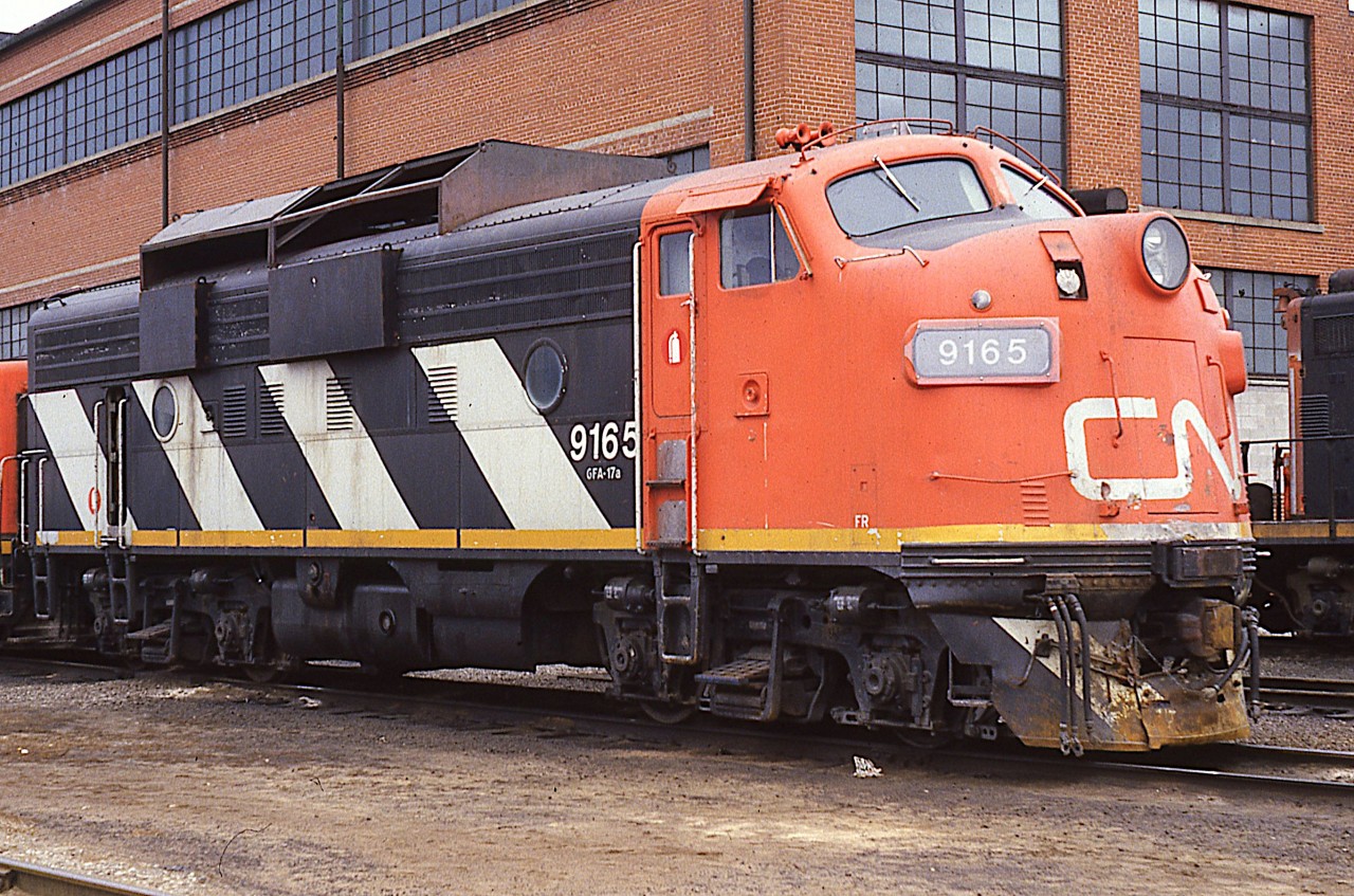 Here's an image of CN 9165, sitting by the shop building in Fort Erie. One would thin being now mid-March, its snow fighting duties are over for another year. Those big shields to keep the snow out of the engine compartments were quite distinctive. I don't know how many were equipped this way but I do recall 9178 at Stratford was another.
This unit was eventually sold to National Railway Equipment.