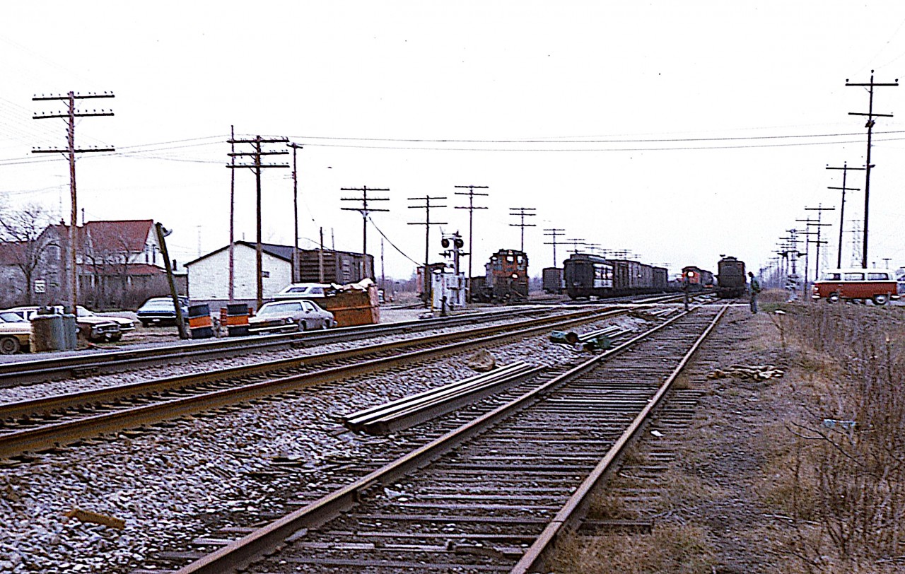 Yes, I realize this is a rather rough image, but it is of interest to the Niagara folk. Once upon a time there was a lot of activity along the Grimsby sub; with all the fruit harvests and related business. Believe it or not, I am standing between the tracks and Railroad Ave (or street?) at Winona Road crossing looking west and there is a freight coming. But look at the other activity!!

 Of course everything today is gone save for the main line. Even the old house on the left.  Its a shame.  So there you have it. Back then, even Winona had a rail yard.
  The station, which would have been to my left about 200 ft down the line, burned down in this time frame. No idea what caused the blaze.