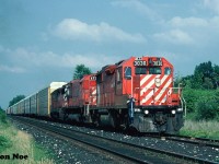 During a hot summer evening a westbound CP train is seen in the siding at Orrs Lake, Ontario on the Galt Subdivision preparing to meet an eastbound. This consist was quite wild even by mid-90’s standards as it included GP38-2 3030, M-636 4721 and GP35 5012. While seeing a big MLW still in operation was awesome, which had now been given a blanked-over cab during reactivation at St-Luc, the real draw was GP35 5012. At the time, the entire fleet of CP GP35’s were assigned to Western Canada and one straying this far east was very un-common. Even in all my trips to CP’s Toronto Yard diesel shop, I never photographed or saw another one after this. 
<br>
M-636 4721 ran for almost one more year before it was “re-retired” on July 5, 1995. While on August 2 ,1996 GP35 5012 was released from CP’s Weston Shops after conversion to control cab-daughter slug 1125. It was mated with GP38-2 ‘mother’ 3035 and assigned to Winnipeg. It was ultimately retired in October 2012. 
