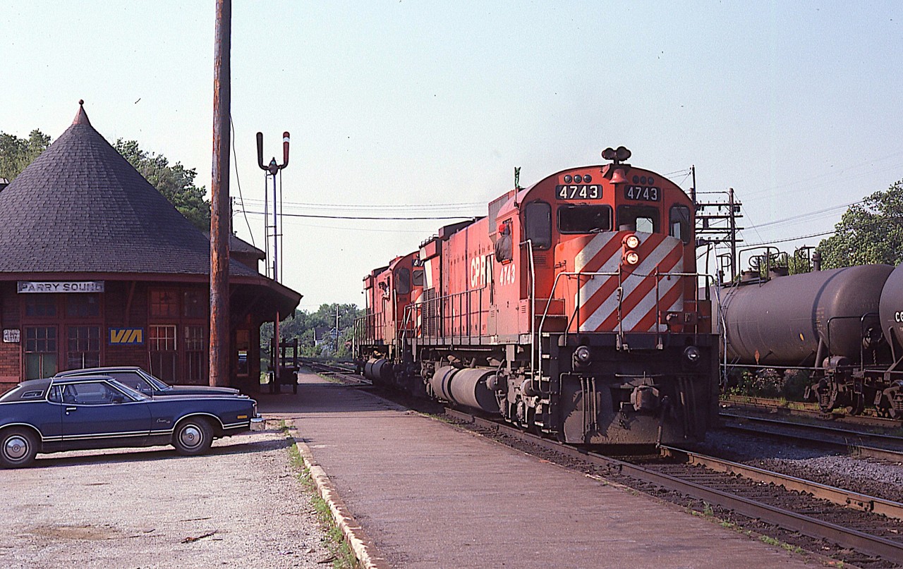 Years ago there actually was some use for a diminutive CP rail yard at Parry Sound. Here we see southbound CP 4743 and 4719 by the station as they were in the process of dropping off a few tanks on the siding and picking up some traffic in the small yard which behind the tanks and a mound of granite rock. Today pretty much all of that is gone, and the station, now used by a commercial outfit, just sees northbound run-thru freights.