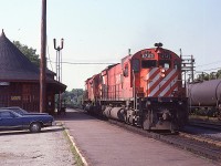 
Years ago there actually was some use for a diminutive CP rail yard at Parry Sound. Here we see southbound CP 4743 and 4719 by the station as they were in the process of dropping off a few tanks on the siding and picking up some traffic in the small yard which behind the tanks and a mound of granite rock. Today pretty much all of that is gone, and the station, now used by a commercial outfit, just sees northbound run-thru freights.