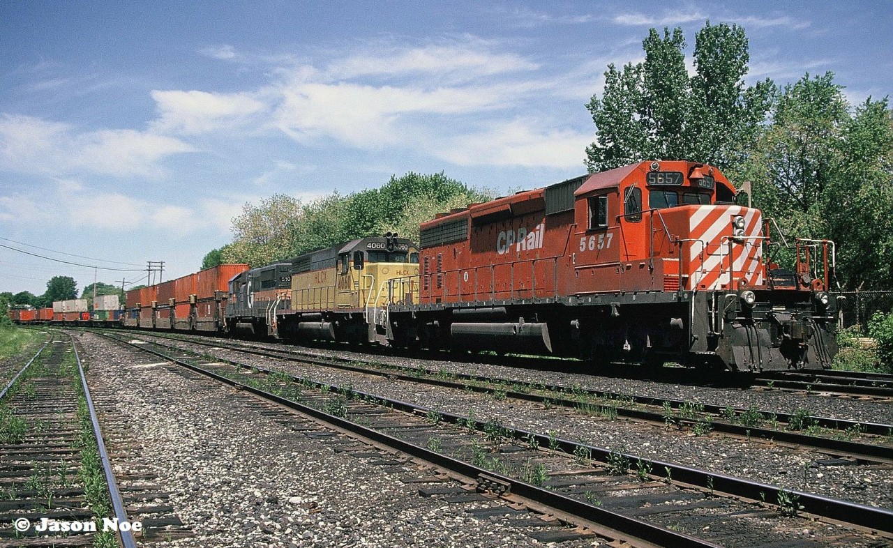 An eastbound CP intermodal train is observed waiting for a new crew at Quebec Street yard in London, Ontario. The train was powered by CP SD40-2 5657, HLCX SD40 4060 and HATX GP40-2 510. Depending on crew availability some crew changes occurred in a timely manner while other trains would sit for much longer waiting.  

HLCX SD40 4060 was built in 1970 as Missouri Pacific 760, prior to becoming Union Pacific 4060. HATX 510 was manufactured during 1977 as Boston and Maine 304. Later it would be rebuilt to become Ontario Northland Railway GP40-2 2202.