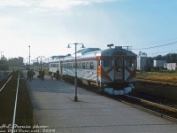 Canadian Pacific "Dayliner" RDC-1 9052 trails a 9100-series RDC-2 on train #337 (Toronto-Windsor), stopped at <a href=http://www.railpictures.ca/?attachment_id=14408><b>West Toronto station</b></a> as passengers cross from the station to board from the center platform. The Budds are seen from the rear Park car of train #12, the southbound Canadian, making its station stop at the same time. Timetables suggest #337 was due at West Toronto at 6:40pm and #12 at 5:55pm, so it's more likely #12 was running a bit behind schedule on its long trip down from Sudbury to Toronto. In the distance one can barely make out the <a href=http://www.railpictures.ca/?attachment_id=42386><b>connecting track</b></a> that #12 snaked through to get from the MacTier Sub north of the interlocking diamond to the station platforms here. On the right, beyond CN's Weston Sub mainline tracks, was the small yard on the S-Yard Lead (the <a href=http://www.railpictures.ca/?attachment_id=38483><b>Old Bruce service track</b></a>, today the West Toronto Railpath).<br><br>At this time CP ran four Dayliner runs on the Toronto-Windsor (once Toronto-Detroit) corridor, #337-340, but #339/340 (that <a href=http://www.railpictures.ca/?attachment_id=36994><b>replaced the #21/22 in 1964</b></a>) were discontinued a few months later in 1969. CP trains #337 and #338 became the final remnants of the <a href=http://www.railpictures.ca/?attachment_id=34193><b>Toronto-Windsor-Detroit corridor</b></a> passenger service on the Galt Sub, that once hosted more frequent train service with <a href=http://www.railpictures.ca/?attachment_id=27810><b>conventional passenger consists</b></a>. They made their last runs in early July 1971.<br><br>Other photos from the day suggest US-based rail photographer Harold Brouse was on a trip coming back from the Algoma Central and CP operations up north in the Sault St. Marie area, and was taking #12 southbound (with FPA2 4083 & an RS10 as power) back to Toronto, possibly to connect with the CP-TH&B Budd car run back to the US.<br><br><i>H.E. Brouse photo, Dan Dell'Unto collection slide.</i>