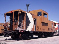 During a pleasant summer morning, damaged CP caboose 434689 and a retired RDC are pictured sitting by the caboose shop in CP’s Toronto Yard. 