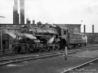 Canadian Pacific 3632, an N2a-class 2-8-0 (built by CLC in 1911), steams outside CP's Lambton Roundhouse in West Toronto between assignments. She was one of the regulars that worked <a href=http://www.railpictures.ca/?attachment_id=21826><b>Port McNicoll</b></a>, that has the distinction of becoming CP's last regular freight steam operation a year later. In the background, new diesel power is present in the form of an MLW FA2 on the adjacent track, and an RS3 poking out of roundhouse stall 16. 
<br><br>
<i>Original photographer unknown, Dan Dell'Unto collection negative.</i>