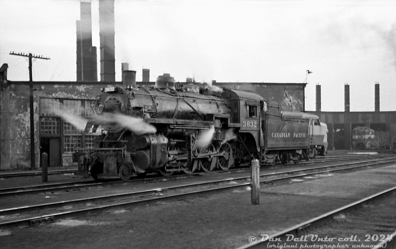 Canadian Pacific 3632, an N2a-class 2-8-0 (built by CLC in 1911), steams outside CP's Lambton Roundhouse in West Toronto between assignments. She was one of the regulars that worked Port McNicoll, that has the distinction of becoming CP's last regular freight steam operation a year later. In the background, new diesel power is present in the form of an MLW FA2 on the adjacent track, and an RS3 poking out of roundhouse stall 16. 

Original photographer unknown, Dan Dell'Unto collection negative.